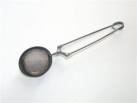 vintage mesh fabric strainer with metal rings on ends|Antique Strainers .